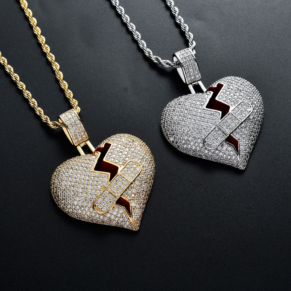 Two heart-shaped pendants on chains against a black background