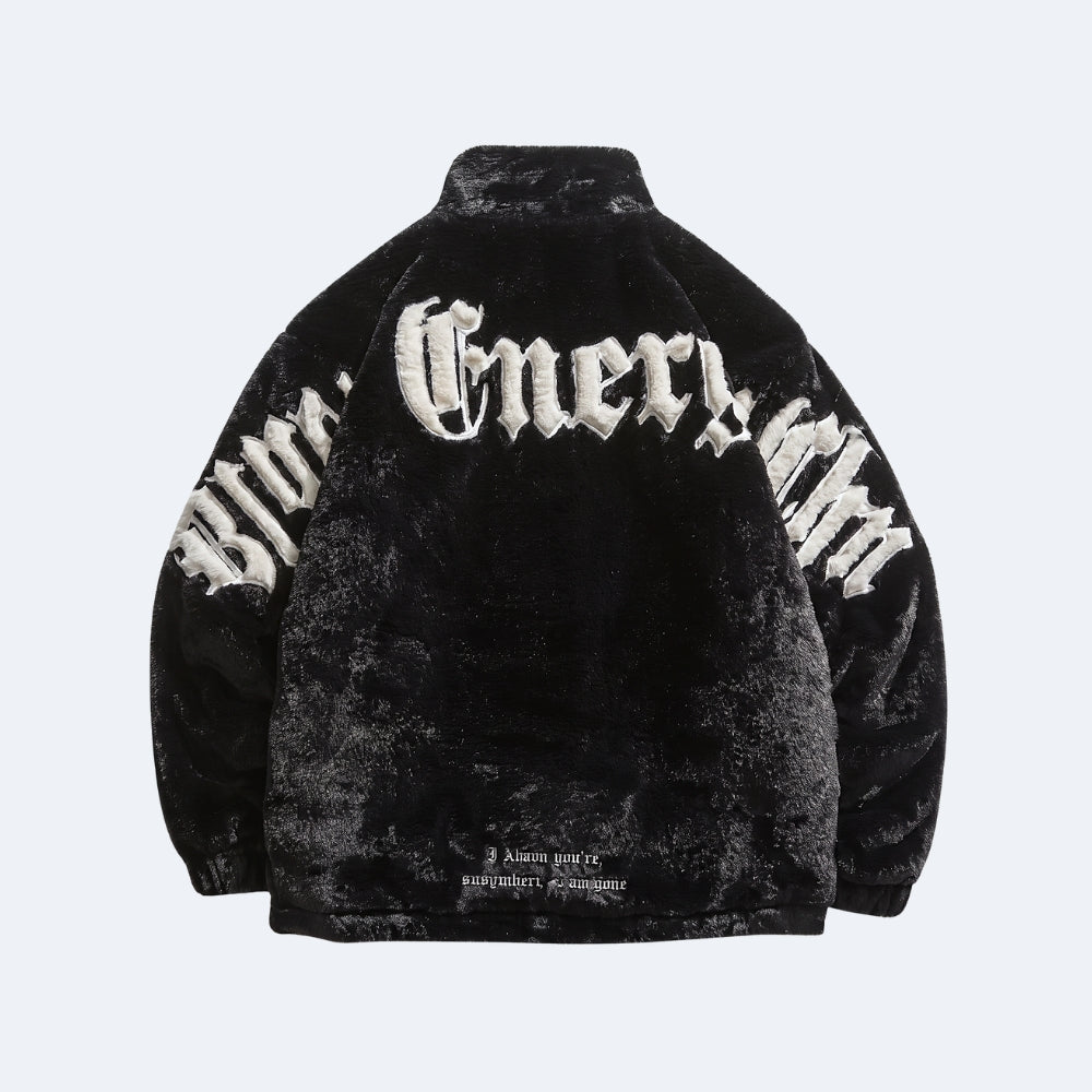 A black velvet half-zip jacket with white embroidered Gothic-style lettering on the back, displayed against a light gray background.