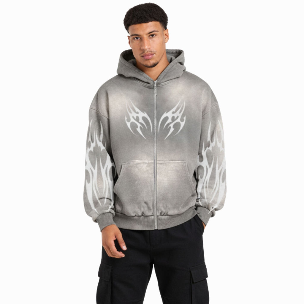 Person wearing a gray hoodie with white flame designs on a white background