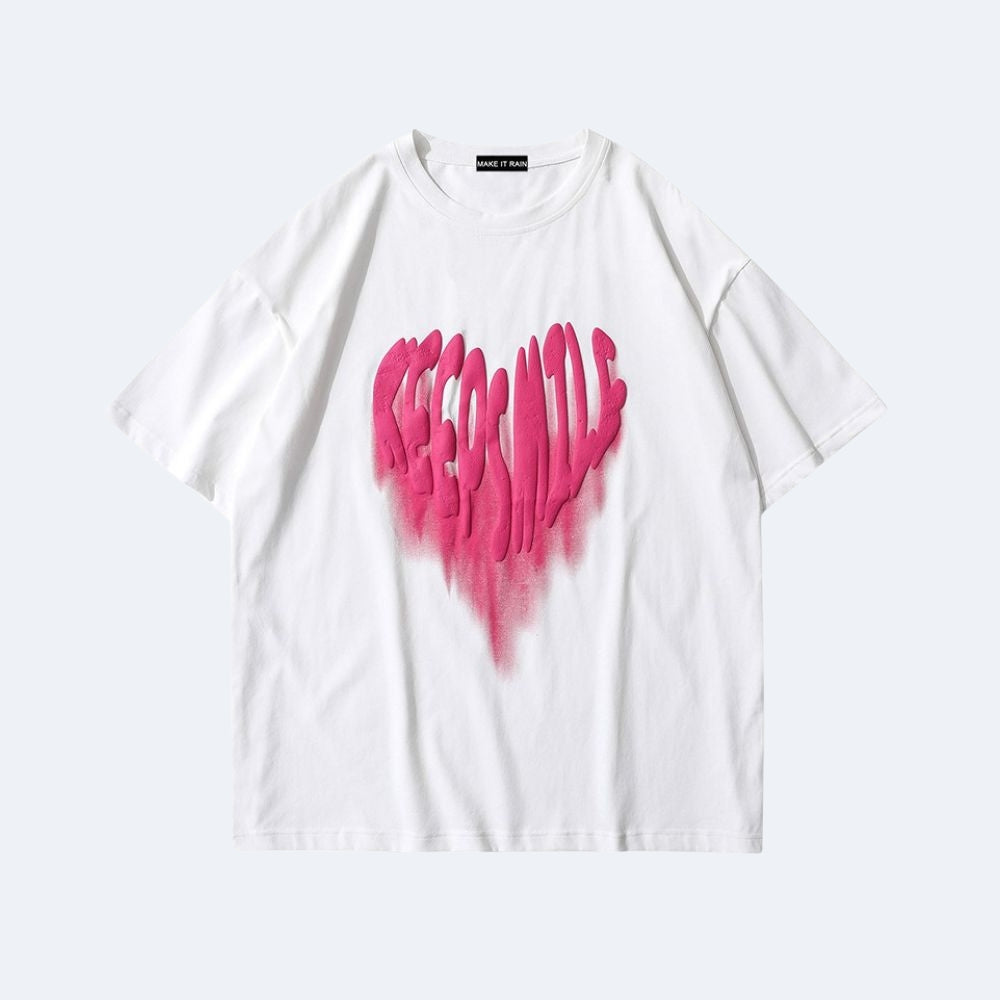 A white short-sleeve crewneck t-shirt featuring a large, vibrant pink dripping heart graphic on the front, displayed against a light gray background.