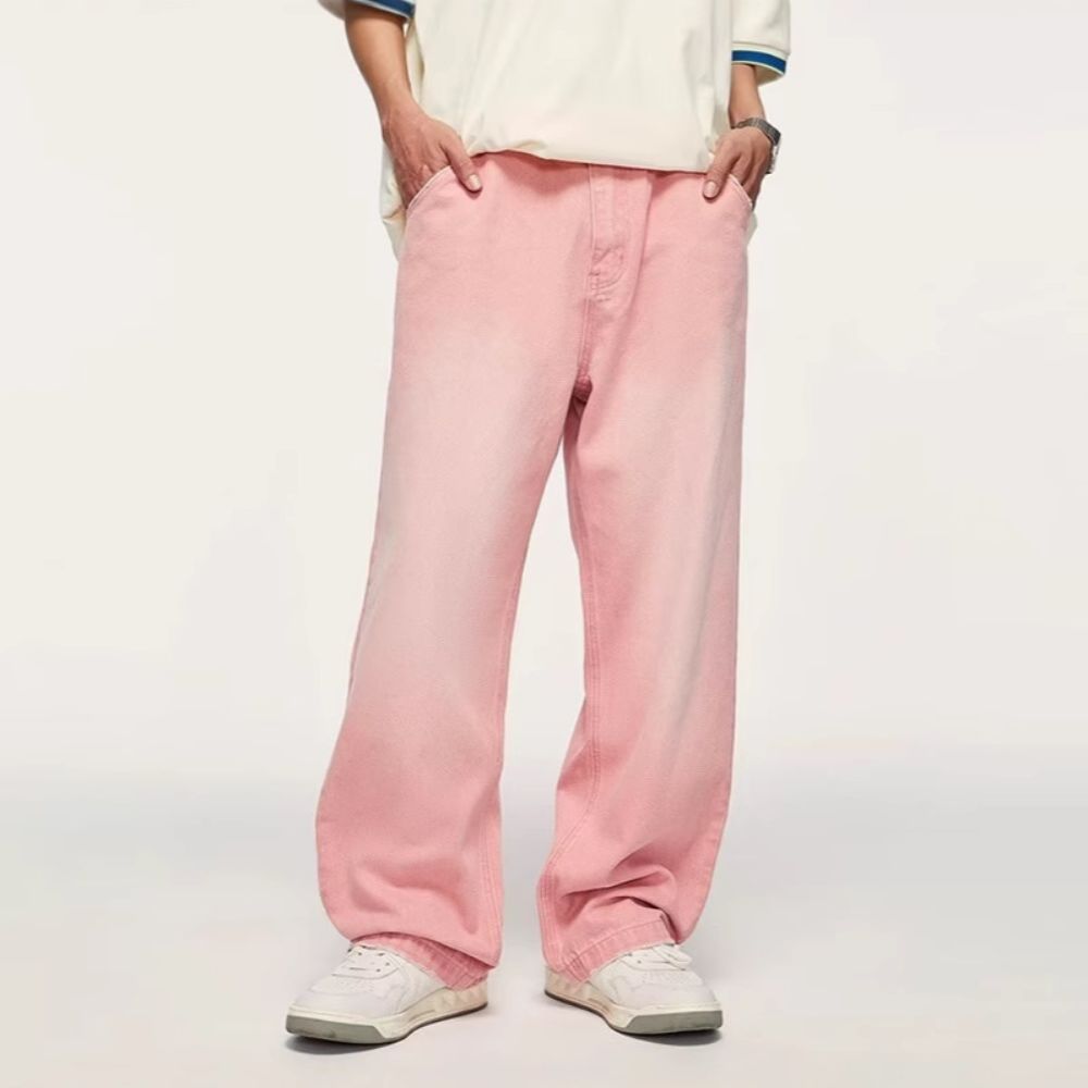 Person wearing pink pants and a white shirt on a plain background