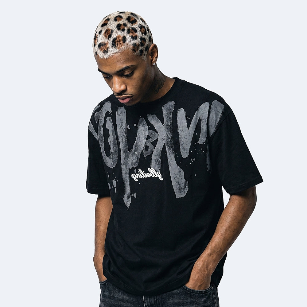 Black. A man wearing a black t-shirt with a large distressed gray and white graphic print on the front.