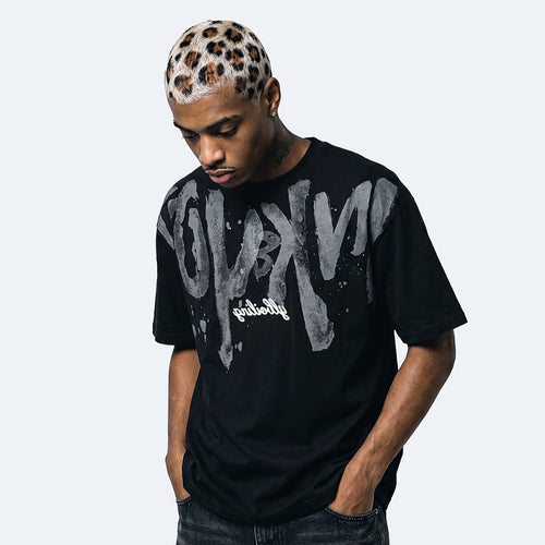 Black. A man wearing a black t-shirt with a large distressed gray and white graphic print on the front.