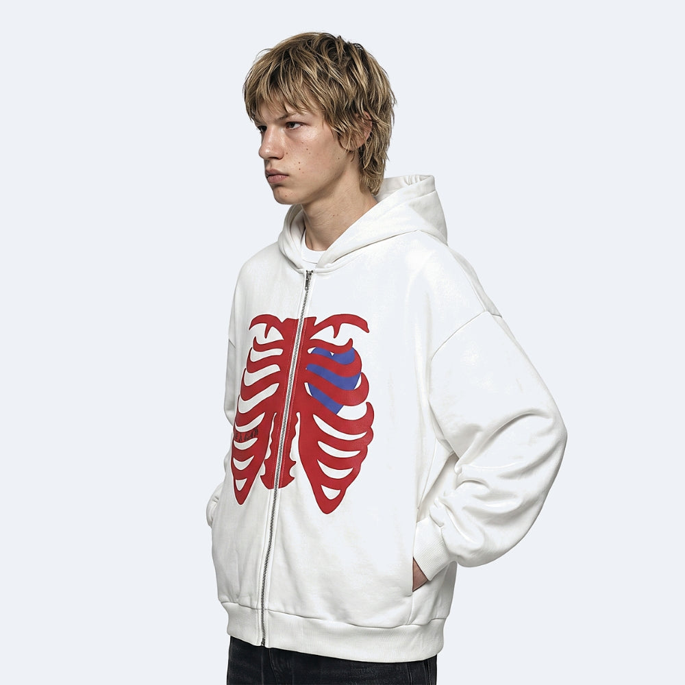 White. A model wearing a white zip-up hoodie with a red rib cage graphic and a blue striped heart detail on the chest.