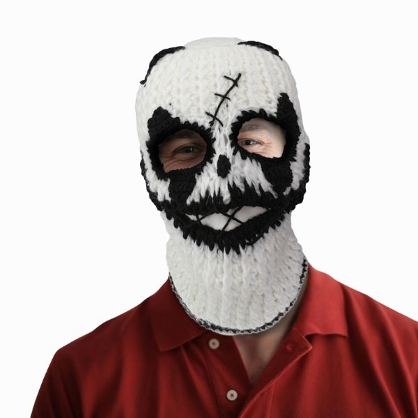 Person wearing a white skull-themed balaclava with black accents on a white background