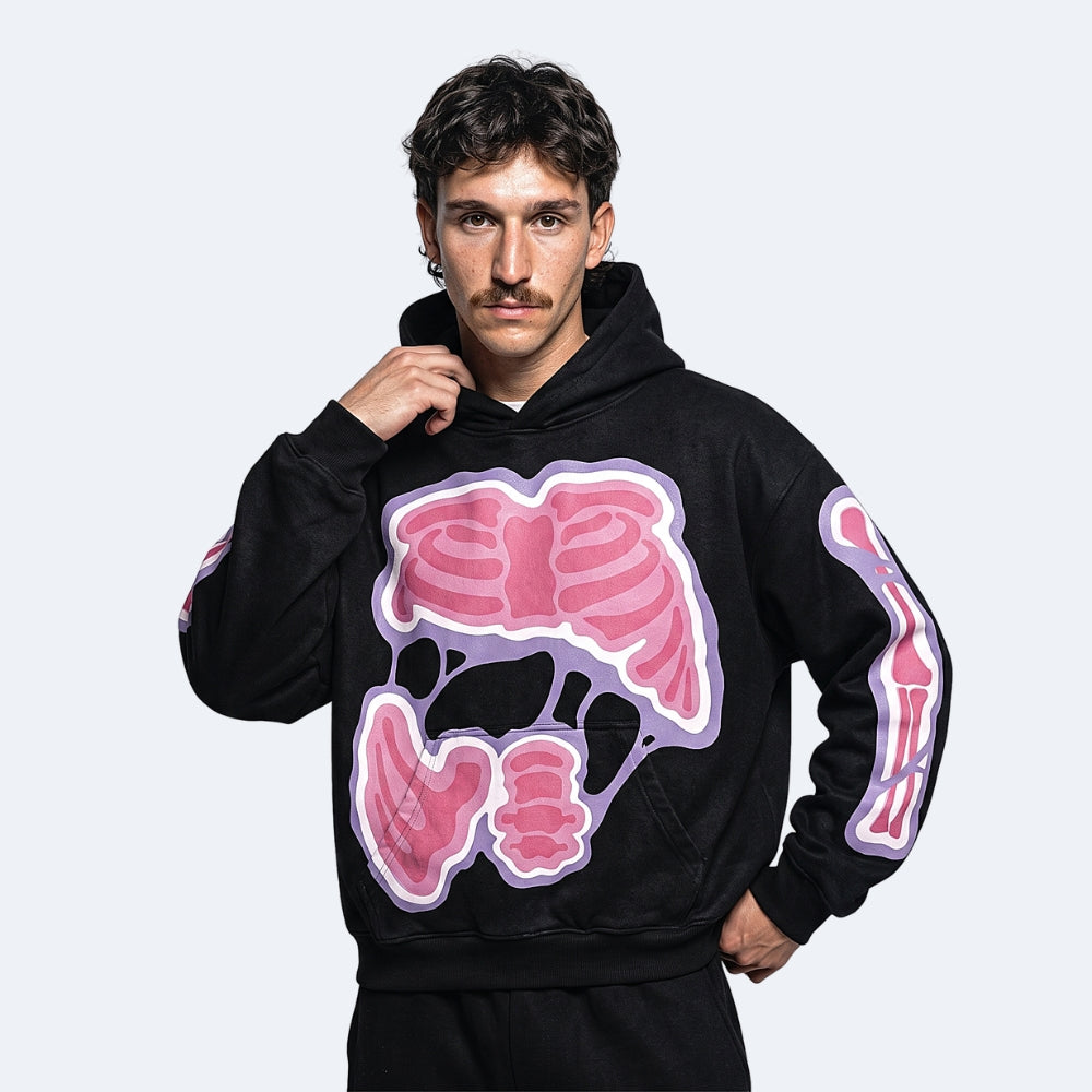 A man wearing a black hoodie with a large pink and purple anatomical intestines graphic on the front and matching sleeve graphics, posed against a light gray background.