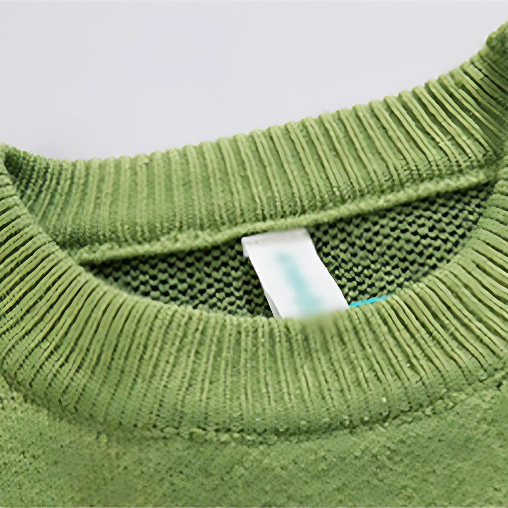 Close-up of a green sweater collar with a brand label.