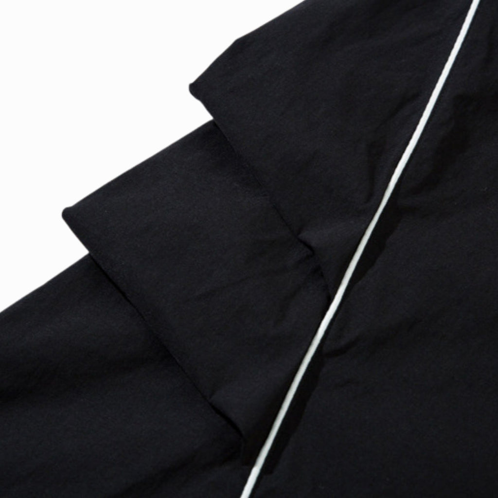 Close-up of black fabric with a white line on a white background