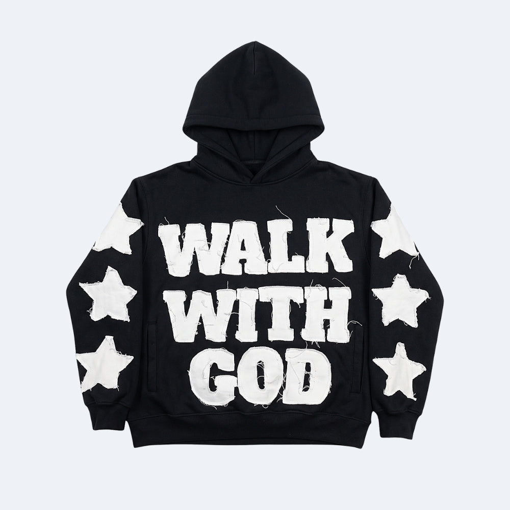 Black. A black pullover hoodie with WALK WITH GOD printed in distressed white block letters across the front, decorated with white star graphics on the sleeves.