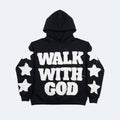 Black. A black pullover hoodie with WALK WITH GOD printed in distressed white block letters across the front, decorated with white star graphics on the sleeves.