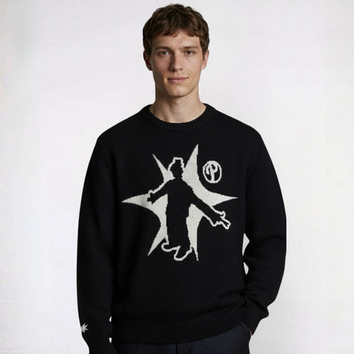 Person wearing a black sweater with a white graphic design on a white background