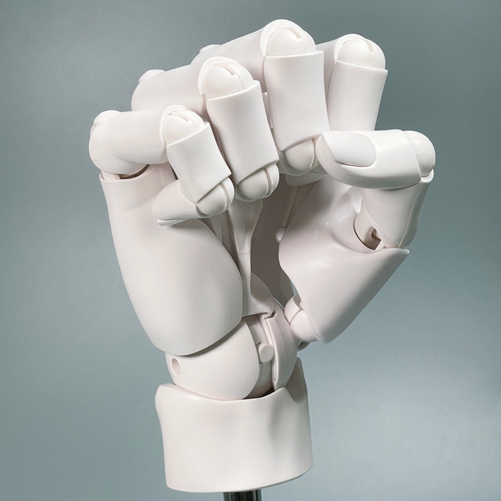 White robotic hand on a gray background