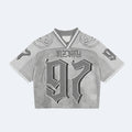 Silver. A cropped short-sleeve jersey top in light gray with a distressed texture, featuring a gothic-style 97, NEZKY across the chest, and skull graphics on the shoulders.