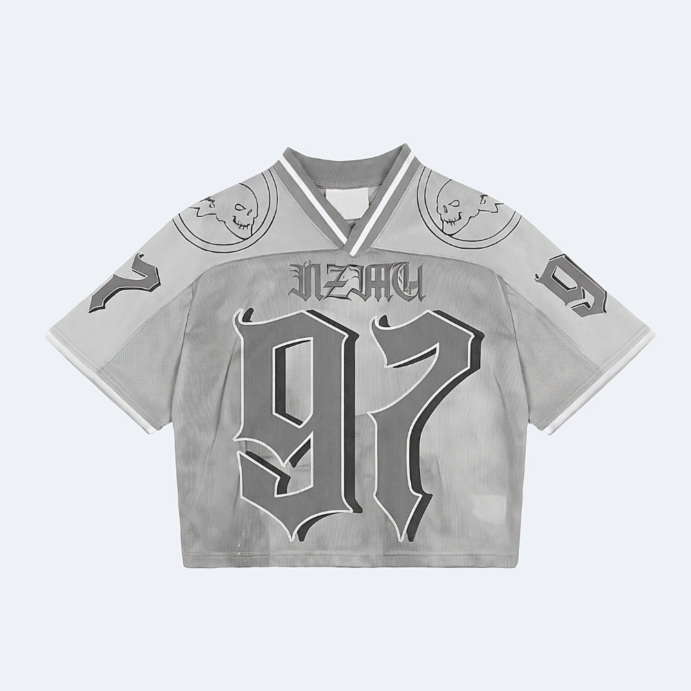 Silver. A cropped short-sleeve jersey top in light gray with a distressed texture, featuring a gothic-style 97, NEZKY across the chest, and skull graphics on the shoulders.
