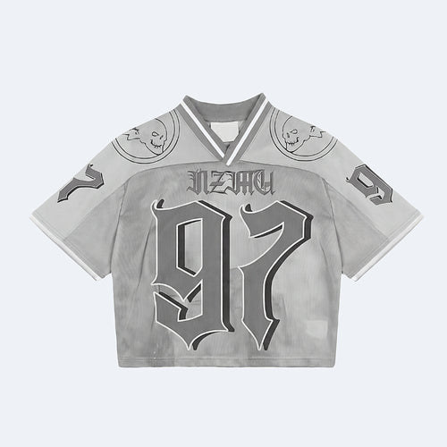 Silver. A cropped short-sleeve jersey top in light gray with a distressed texture, featuring a gothic-style 97, NEZKY across the chest, and skull graphics on the shoulders.