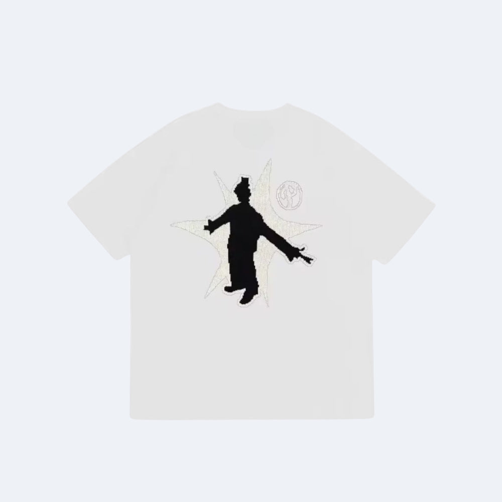 White. An off-white short-sleeve t-shirt featuring a black silhouette of a figure with outstretched arms over a white star graphic, with a circular emblem on the upper right chest.