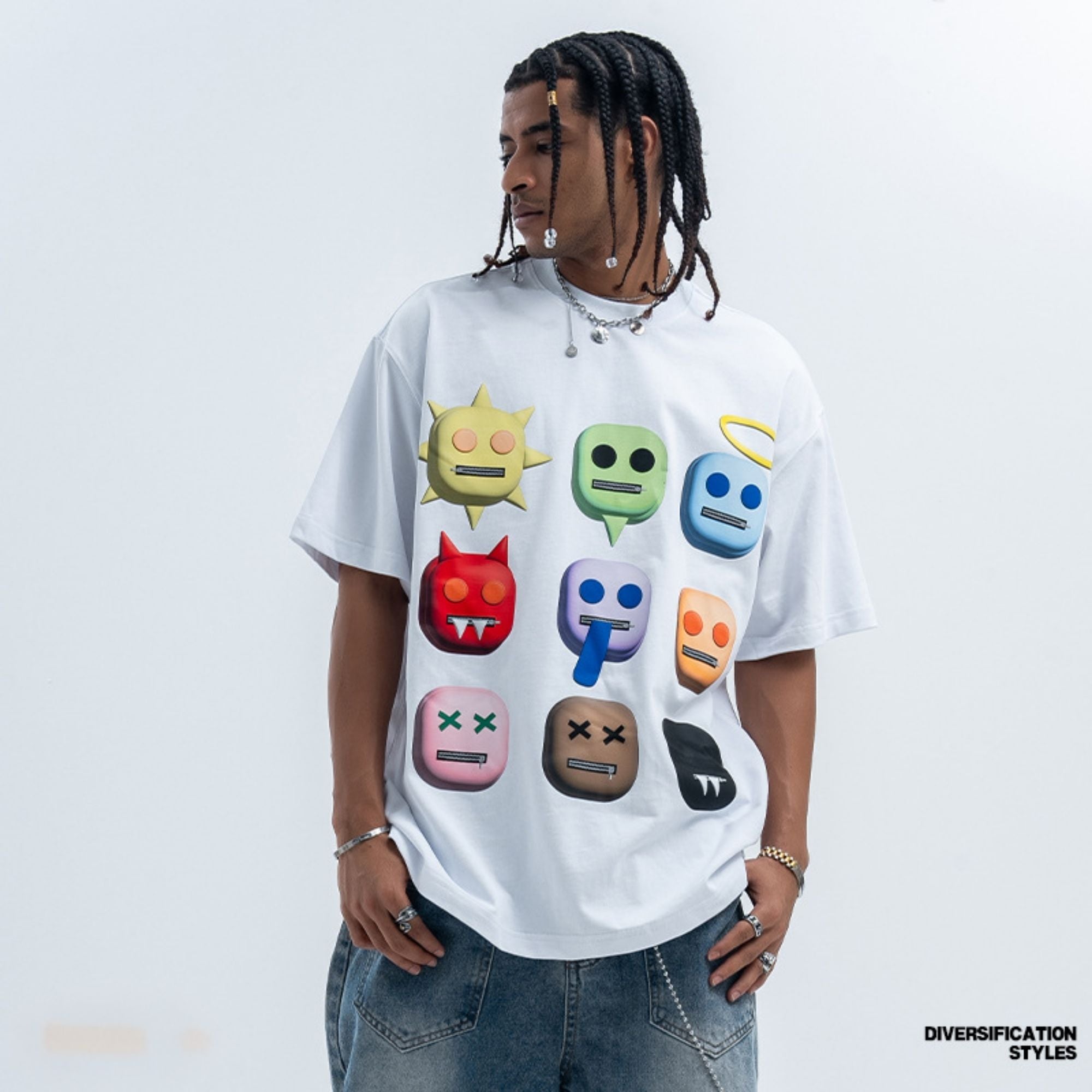 Person wearing a white t-shirt with colorful emoji designs on a light gray background