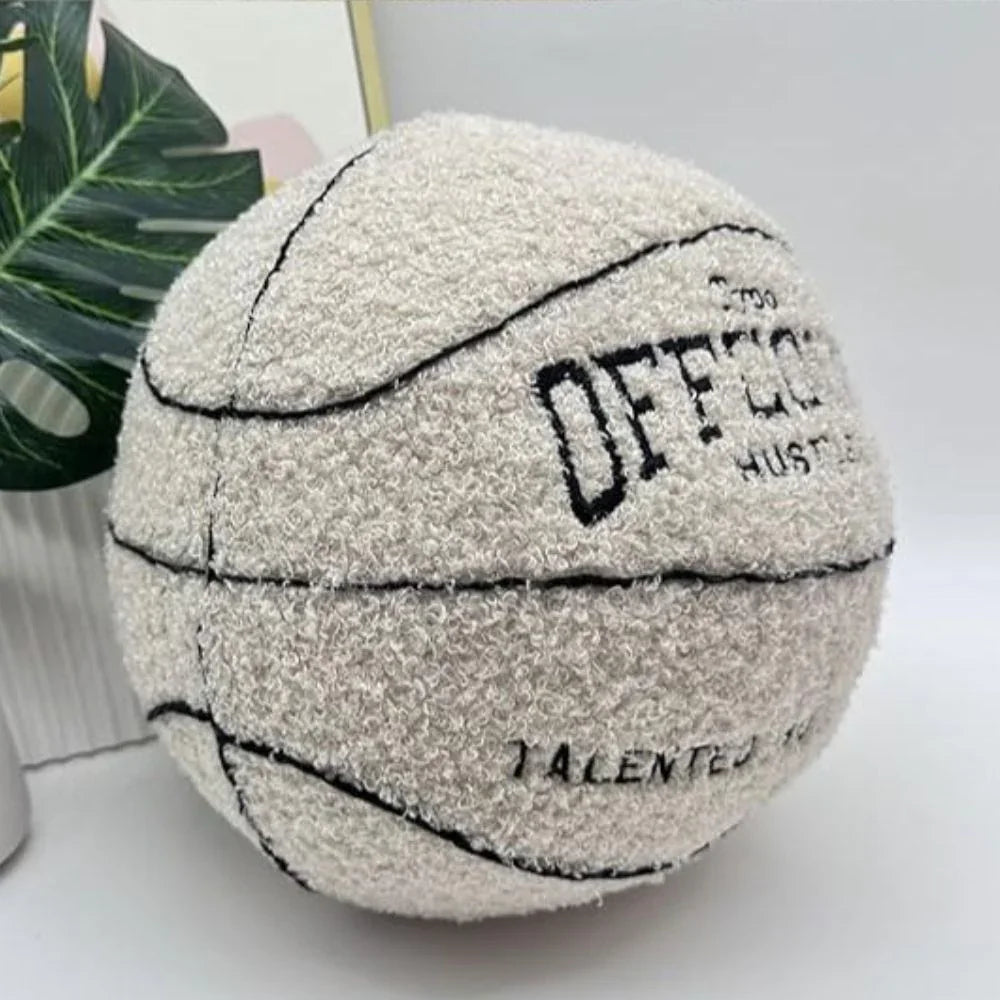 Textured pillow basketball with motivational phrases on a light background