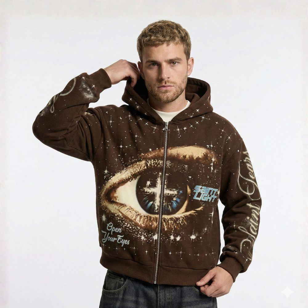 Man wearing a brown hoodie with eye design and text on a white background