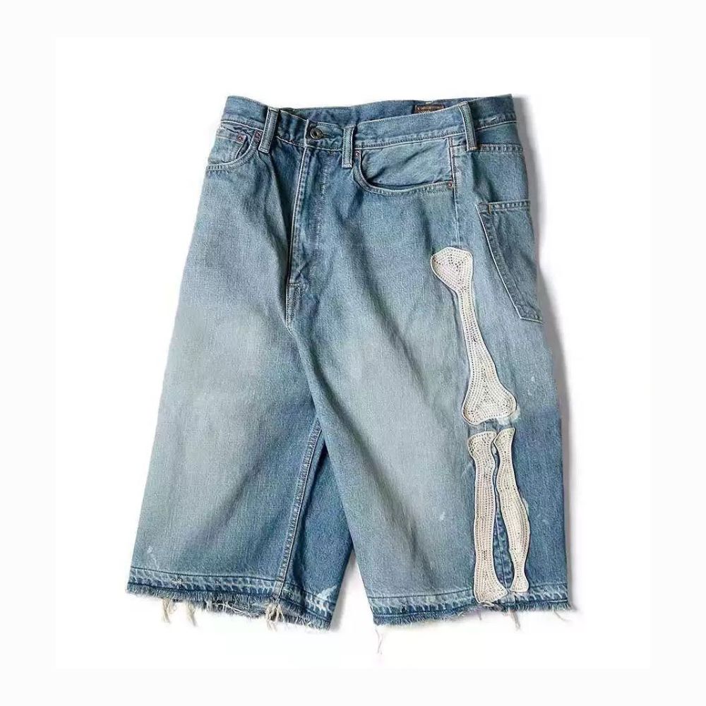 Blue denim shorts with a skeleton design on a white background