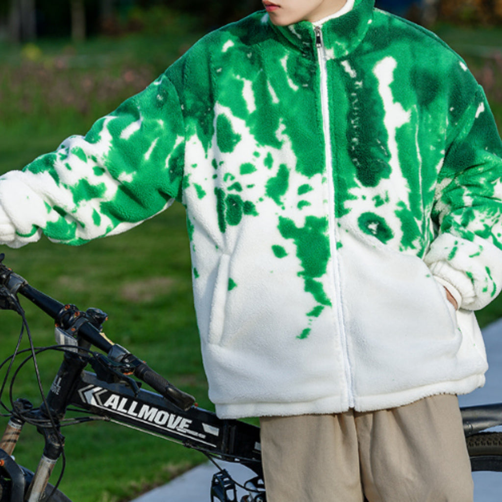 Person wearing a green and white jacket with a bicycle in the background