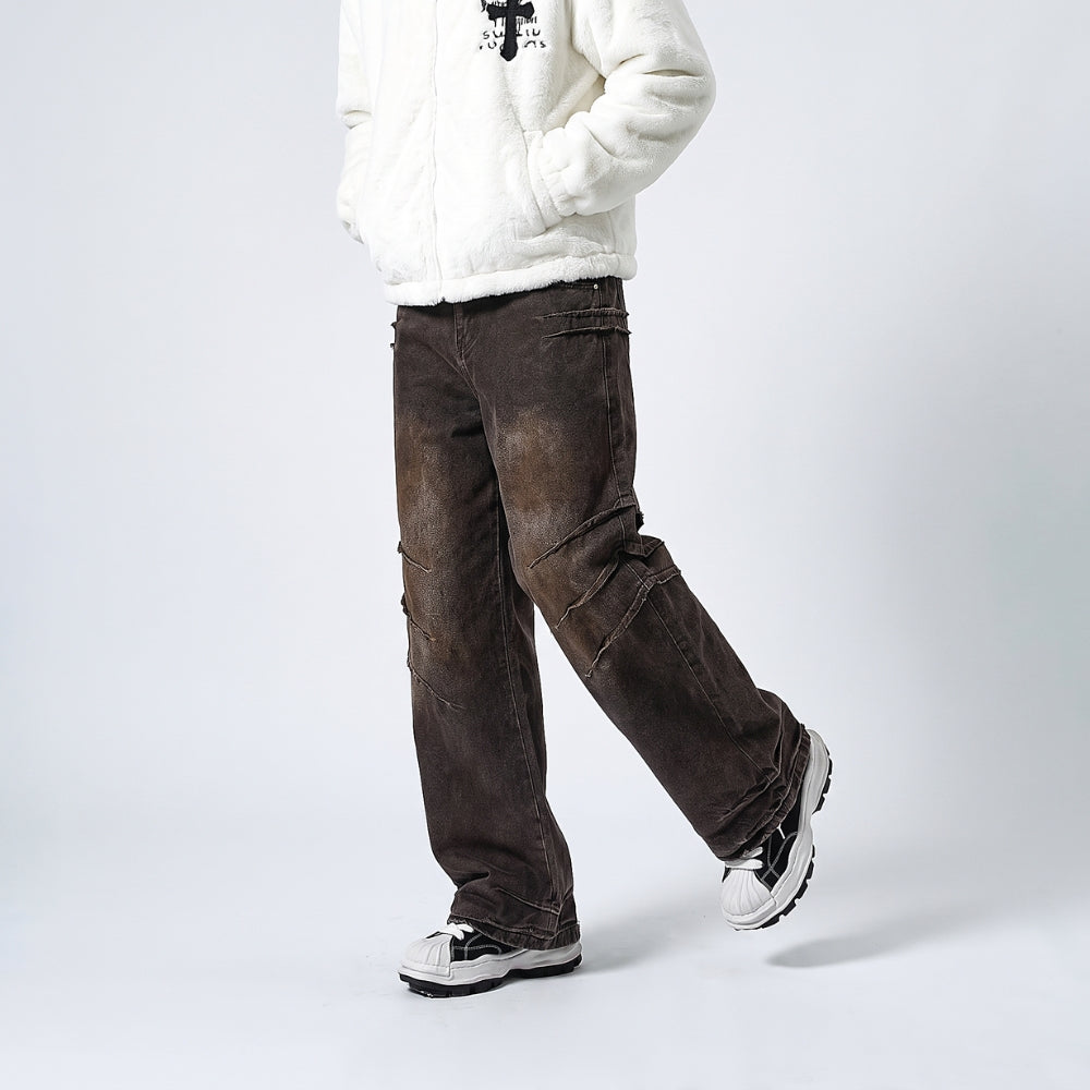 A person wearing dark brown washed denim cargo pants, a white sherpa fleece zip-up jacket, and white sneakers, standing against a light gray studio background.