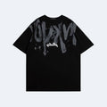 Black. A black short-sleeve t-shirt with a large distressed gray graffiti-style graphic across the chest and a small white script logo below it.