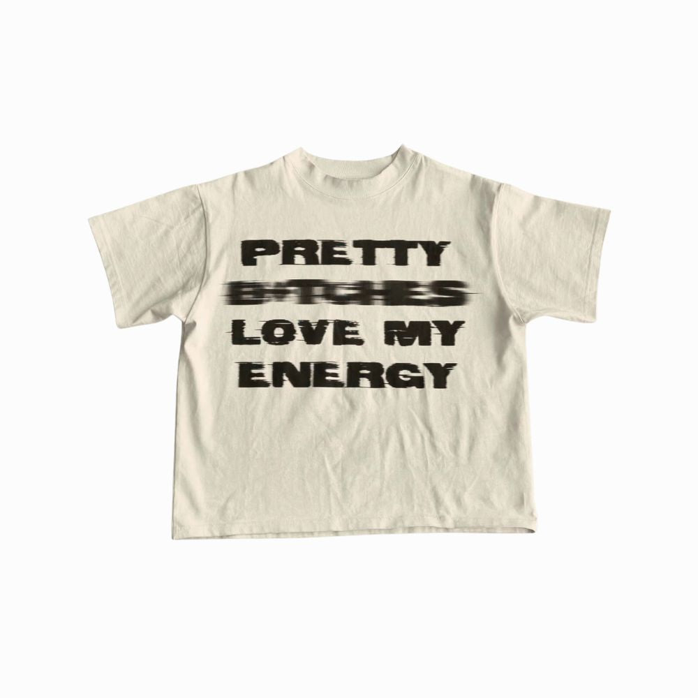 Beige t-shirt with black text 'PRETTY BØCHES LOVE MY ENERGY' on a white background