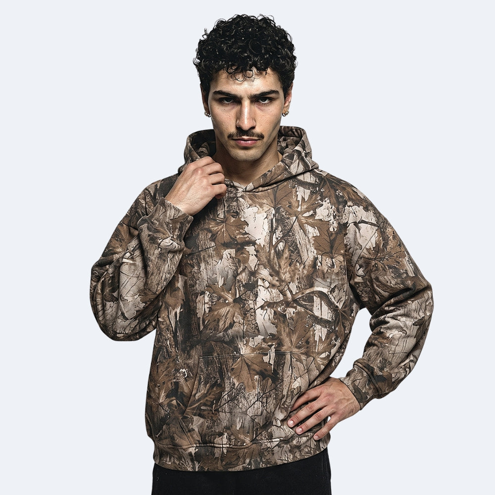 Oak. A man wearing a brown and beige camouflage hoodie.
