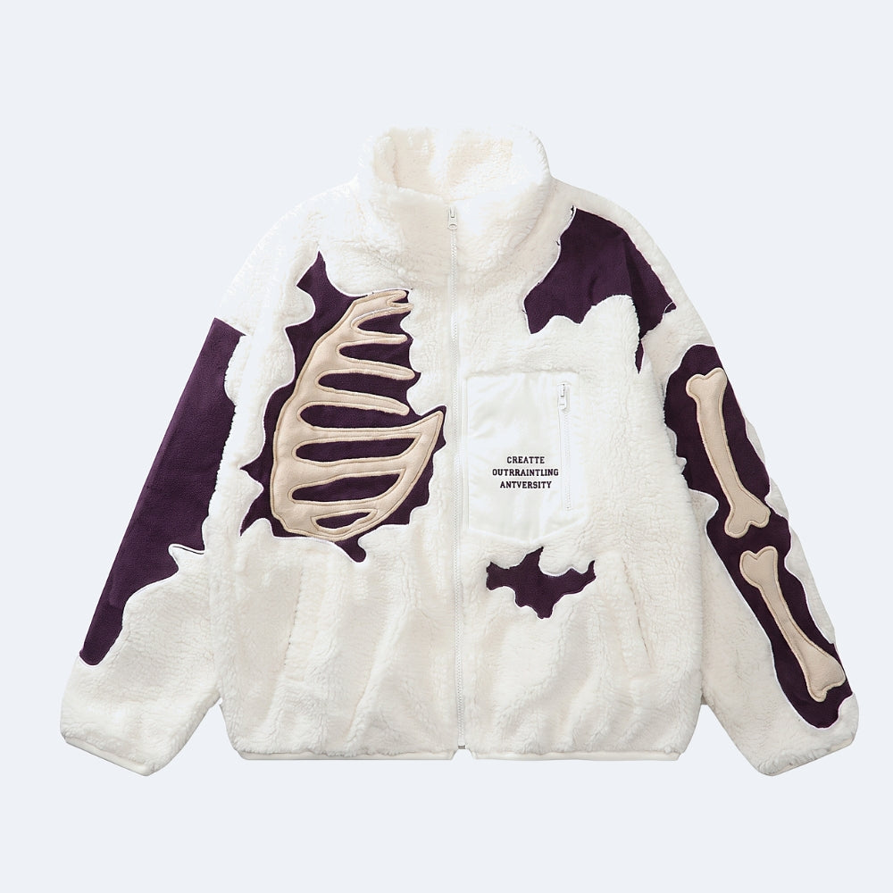 White. A white sherpa fleece zip-up jacket with a skeleton rib cage and bone graphic design in beige and dark purple, featuring a front pocket with text.