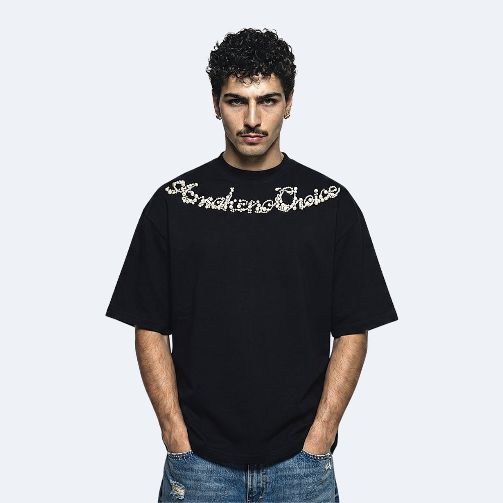 Black. A man wearing a black short-sleeve t-shirt with Smokers Choice written across the chest in white cursive lettering, paired with blue jeans.