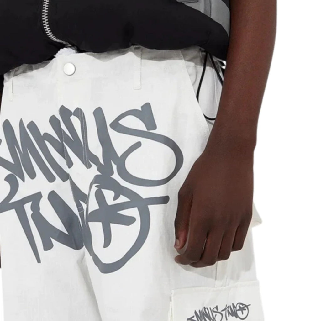 White pants with black text design worn by a person on a white background