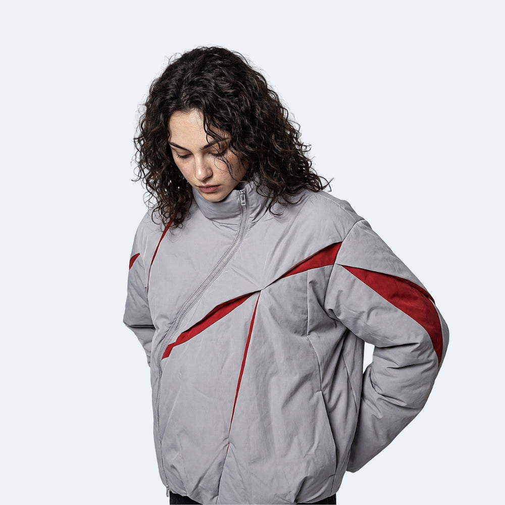 Clear. A model wearing the KRUX Asymmetry puffer jacket in the Clear colorway.