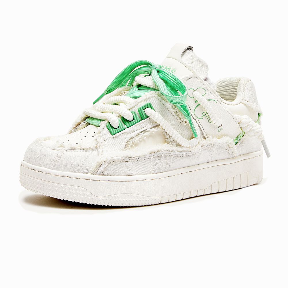 White sneaker with green accents on a white background