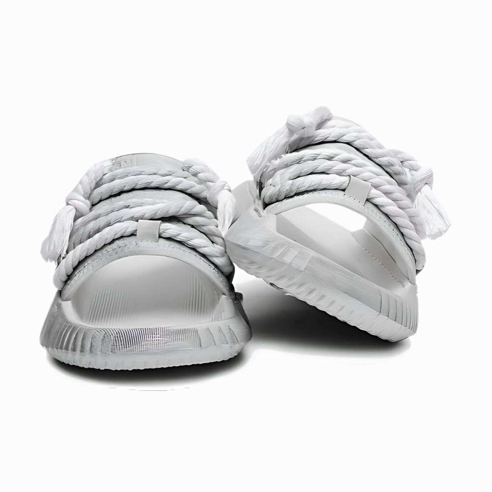 White sneakers with braided design on a white background