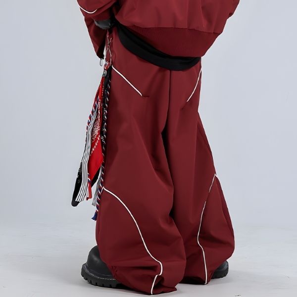 Red snow pants with white accents on a plain background