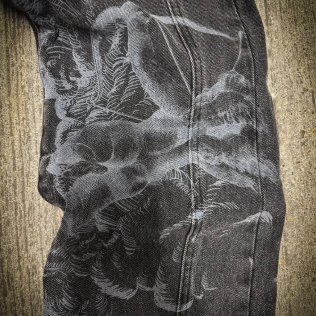 Close-up of a black and white floral pattern on a textured surface