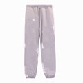 Gray sweatpants with white splatter patterns on a white background