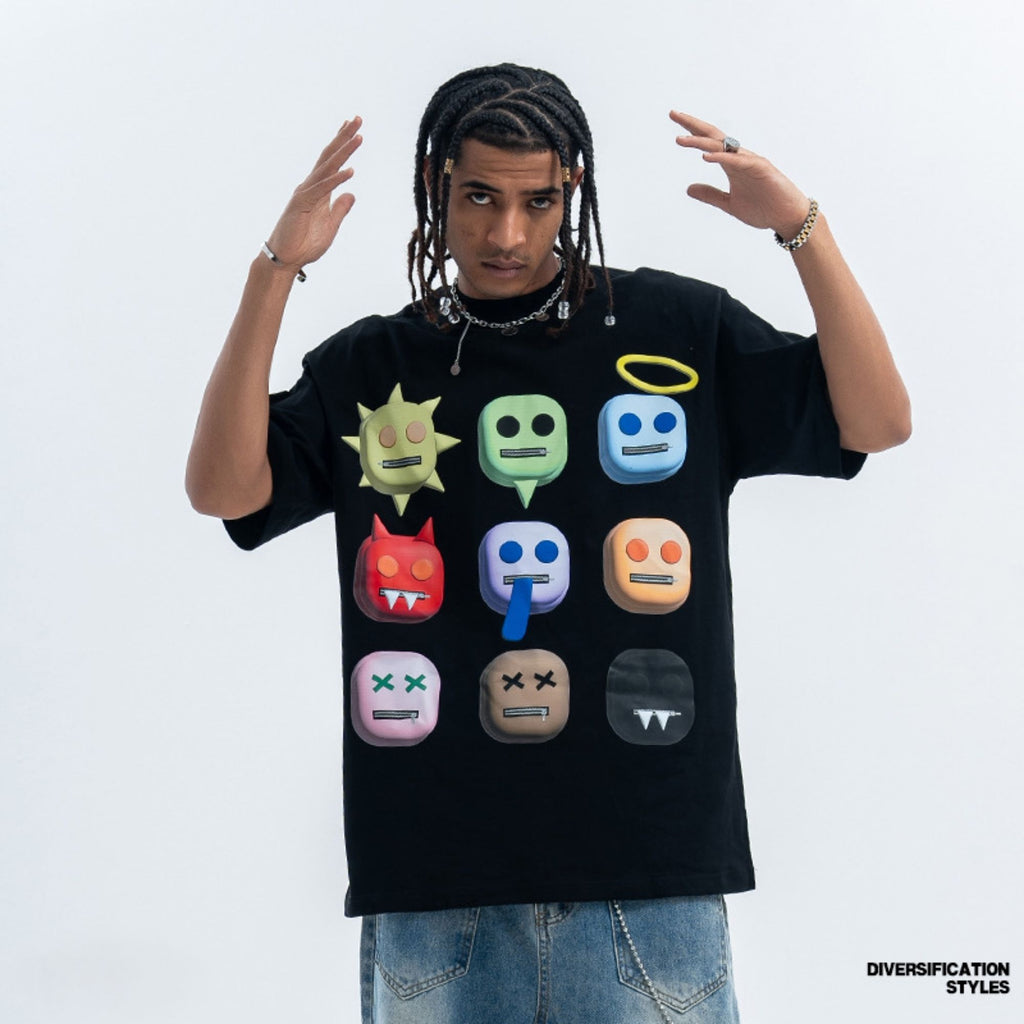 Person wearing a black t-shirt with colorful emoji designs on a white background