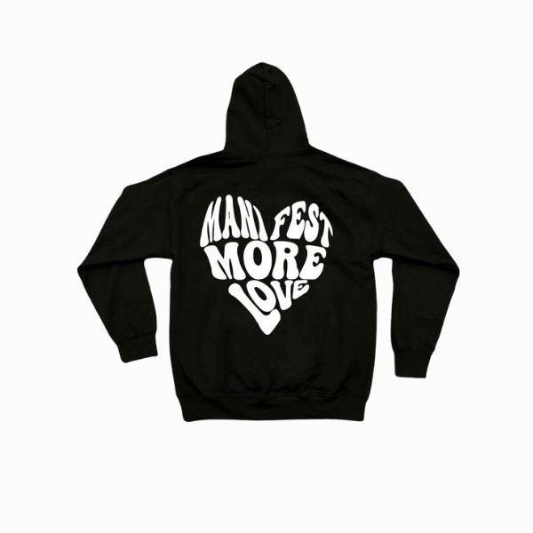 Black hoodie with 'Manifest More Love' text on the back against a white background