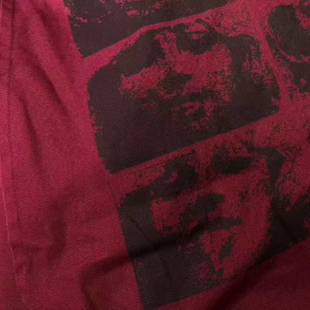 Close-up of red fabric with black abstract pattern