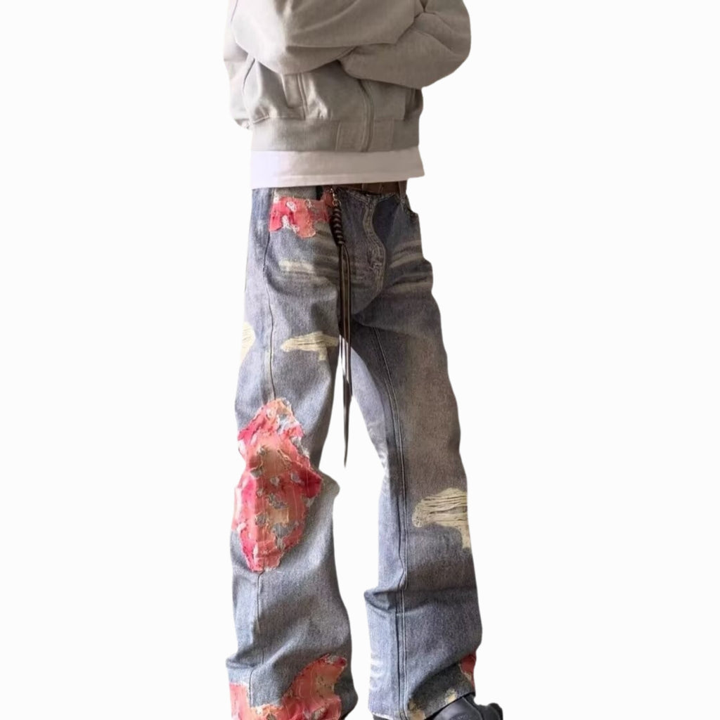 Person wearing jeans with floral designs on a white background