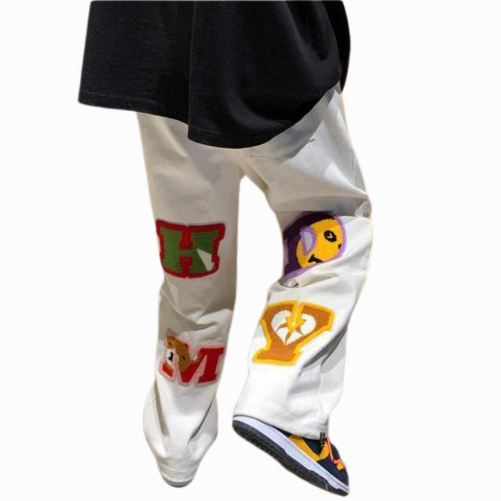 White pants with colorful graphics and text on a white background