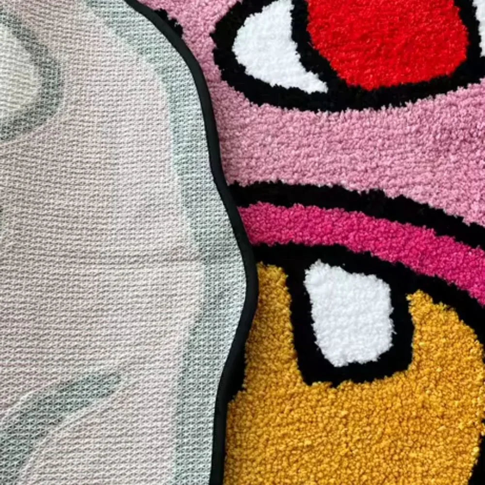 Close-up of a colorful cartoon character rug with pink, yellow, and red colors.