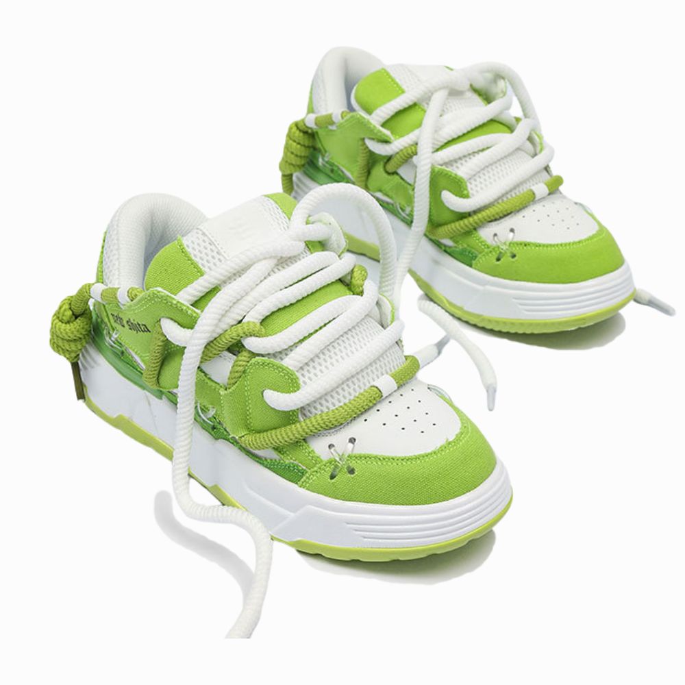 Green and white sneakers with white laces on a white background