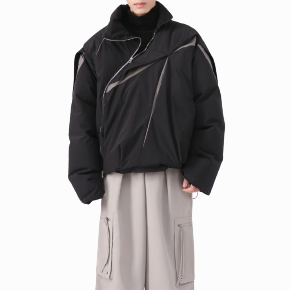 Person wearing a black jacket with gray accents on a white background