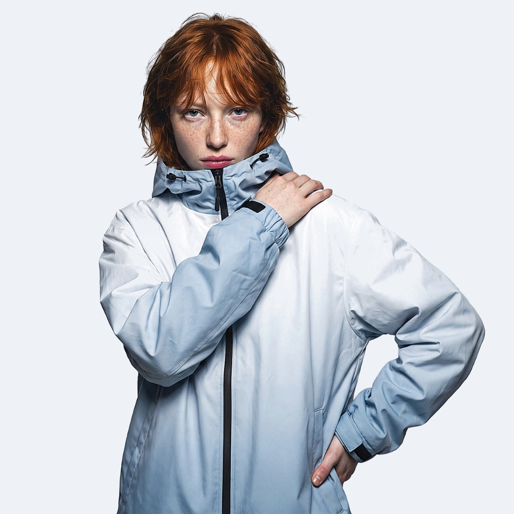 Blue. A model with red hair and freckles wearing a light blue and white hooded jacket.