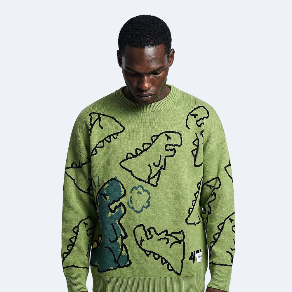 Green. A man wearing a light olive green crewneck sweater with a knitted dinosaur pattern.