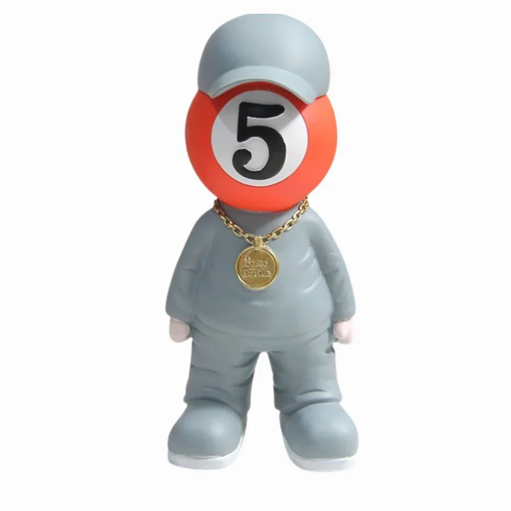 Toy figure with a number 5 ball on its head and a gold necklace with a pendant.