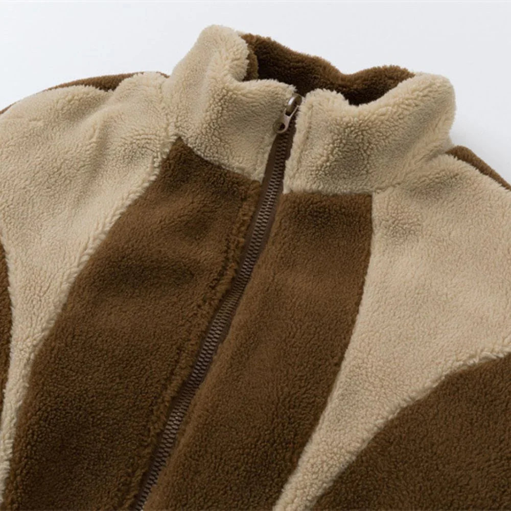 Close-up of a brown and beige fleece jacket with a zipper.